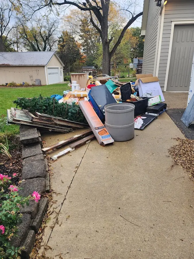 Dumpster being loaded with debris for Estate Cleanout Dumpster Rental in Riverside